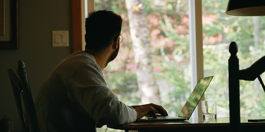 man in gray hoodie using laptop computer